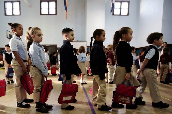 Students line up March 18 at Alma Del Mar Charter School in New Bedford. PETER PEREIRA/STANDARD-TIMES FILE/SCMG