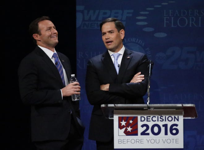 Sen. Marco Rubio, right, and Rep. Patrick Murphy chat during a break in a debate Wednesday at Broward College in Davie. Rubio and Murphy held their second and final debate, 13 days before the election. (AP Photo/Wilfredo Lee)