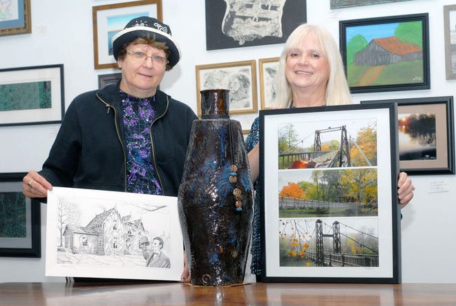 Brenda Thompson, left, and Vickie Fitzgerald showcase a few of the pieces for those who complete the Pontiac Community Art Center art walk on Nov. 5.