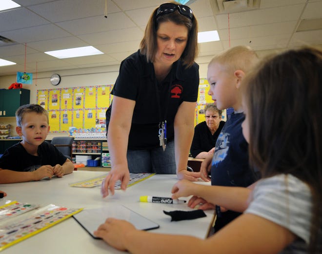 Sherry Halferty, a kindergarten teacher at Oakdale Elementary School, works with her students Wednesday afternoon.