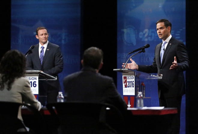 Sen. Marco Rubio, right, gestures as he and Rep. Patrick Murphy, left, answer questions from a panel during a debate, Wednesday at Broward College in Davie. (AP Photo/Wilfredo Lee)