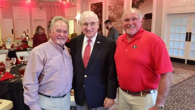 Former Georgia football coach Vince Dooley, center, shares a moment with Bulldogs fans John Keith, left, and Jeff Lee, right, at the Salvation Army's Gala on Wednesday night at The Landings. Mike Brown/For the Savannah Morning News