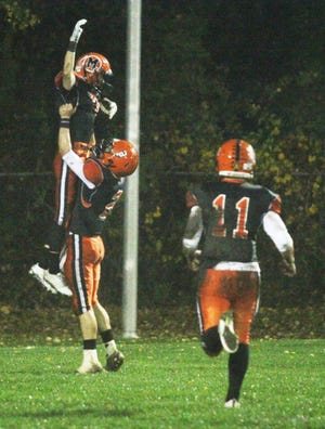 Colin O'Brien celebrates his touchdown with Jason Bean, as Harrison LaPierre runs to the scene to join them, during the Sachems' 46-16 win over Rockland Friday night at Battis Field. This week, the Sachems are headed back to Holliston for the third straight year to face the Panthers in the MIAA playoffs. Kickoff is Friday night at 7 pm at Holliston High School. Jon Haglof/The Gazette/SCMG