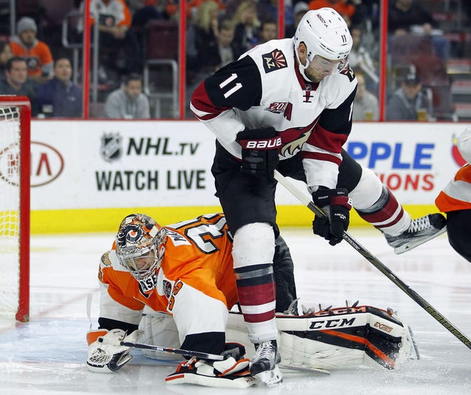 The Coyotes' Martin Hanzal (11) steps over the Flyers' Steve Mason during the third period Thursday, Oct. 27, 2016, in Philadelphia.