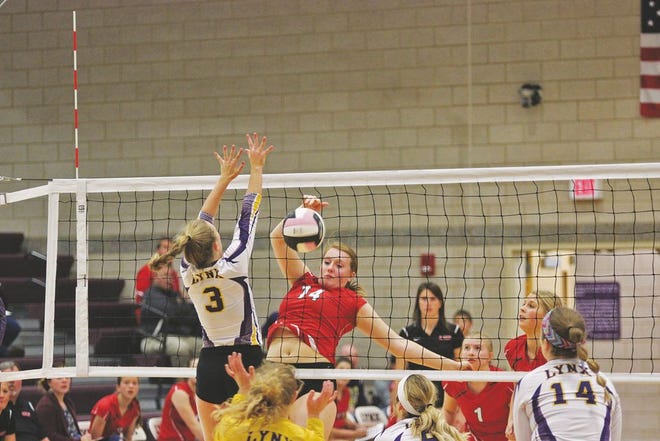 Boone’s Claire Sandvig (14) sends one of her team leading 16 kills down for a point Tuesday in Webster City.