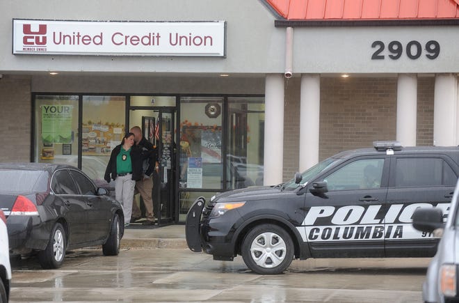 Columbia police detectives investigate an armed robbery Wednesday Oct. 26, 2016 that began at about 9:39 a.m. at the United Credit Union at 2909 Falling Leaf Lane.