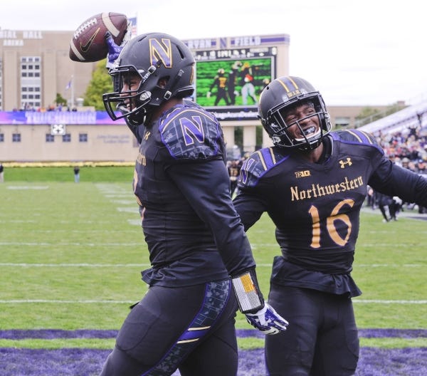 Northwestern safety Godwin Igwebuike, right, celebrates with linebacker Anthony Walker, who returned a fumble for a touchdown against Minnesota in a win last season.