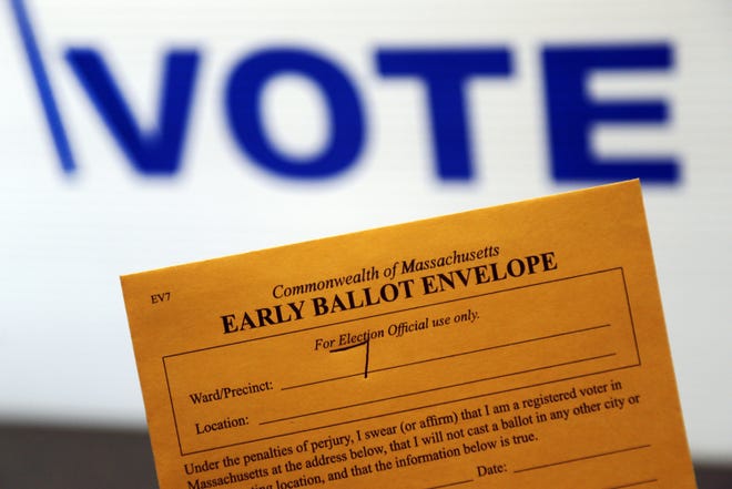 In this Oct. 24, 2016, photo, an early ballot envelope is held at town hall in North Andover, Mass. The millions of votes that have been cast already in the U.S. presidential election point to an advantage for Hillary Clinton in critical battleground states, as well as signs of strength in traditionally Republican territory. (AP Photo/Elise Amendola)