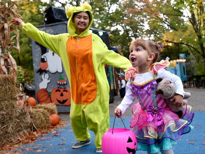 Leah Judware, 3, and Doris Zhu, both of Erie, dance to "The Monster Mash" during ZooBoo, continuing through Sunday at the Erie Zoo. DAVE MUNCH/ERIE TIMES-NEWS