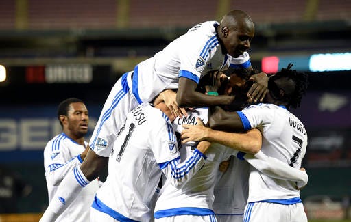 Montreal Impact defender Hassoun Camara, top, and Dominic Oduro (7) and others celebrate a goal by Laurent Ciman, second from right, during the first half of an MLS playoff soccer match against D.C. United, Thursday, Oct. 27, 2016, in Washington. (AP Photo/Nick Wass)