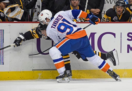 New York Islanders center John Tavares (91) checks Pittsburgh Penguins center Sidney Crosby (87) during the second period of an NHL hockey game on Thursday, Oct. 27, 2016, in Pittsburgh. (AP Photo/Fred Vuich)