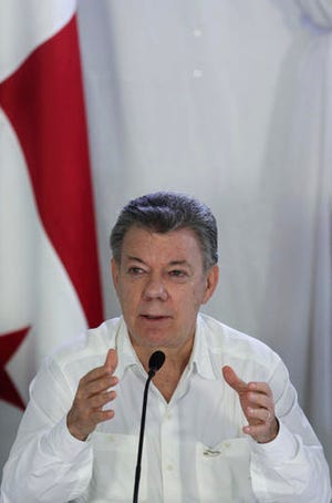 Colombia's President Juan Manuel Santos speaks during a press conference after a meeting with his Panamanian counterpart Juan Carlos Varela at the Nicanor Air Naval base in Darien province, Panama, Tuesday, Oct. 25, 2016. Santos and Varela discussed security and immigration issues between both countries. (AP Photo/Arnulfo Franco)