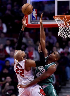 Chicago's Taj Gibson (22) shoots over Boston's Al Horford (42) during the second half of Thursday's game. AP Photo