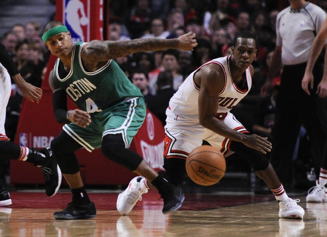 Boston's Isaiah Thomas, left, and Chicago's Rajon Rondo battle for a loose ball during Thursday's game.
