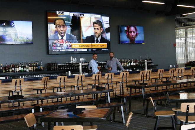 Chris Manuel (left) and Reed Sjostrom, owners of the Owly Oop Sports Pub at the UW Health Sports Factory in Rockford, stand at the restaurant's bar and video wall. The restaurant is set to open Tuesday, Nov. 1, 2016.