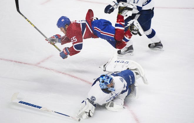 Montreal Canadiens' Andrew Shaw (65) collides with Tampa Bay Lightning's goaltender Ben Bishop during the first period of an NHL hockey game in Montreal on Thursday, Oct. 27, 2016. THE ASSOCIATED PRESS / GRAHAM HUGHES