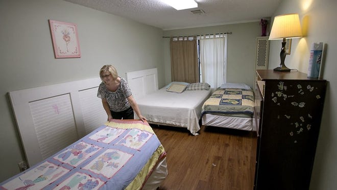 Patty Conner, executive director of Hope Alliance, which operates Williamson County’s shelter for domestic violence victims at a small, overcrowded facility in Round Rock, makes a bed in one of the rooms and is hopeful a new center can be built on donated land.