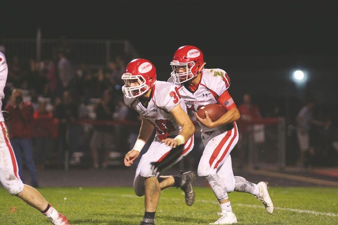 Boone's Tanner Schminke (right) runs with Kaden Sherrard. Schminke scored two rushing touchdowns, including the score to set up the game-winning two-point conversion.