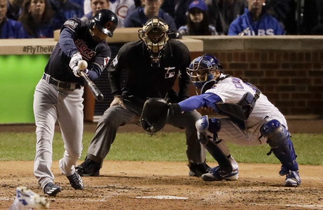Cleveland's Coco Crisp hits an RBI single against the Chicago Cubs during the seventh inning of Game 3 of the World Series on Friday in Chicago. ASSOCIATED PRESS/CHARLIE RIEDEL