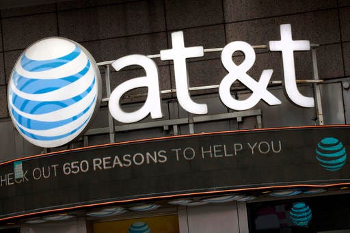 The AT&T logo is positioned above one of its retail stores, Monday, Oct. 24, 2016, in New York. AT&T plans to buy Time Warner for $85.4 billion. (AP Photo/Mark Lennihan)