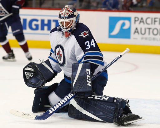 Winnipeg Jets goalie Michael Hutchinson makes a save with his skate on a shot from a Colorado Avalanche player during the third period of an NHL hockey game Friday, Oct. 28, 2016, in Denver. The Jets won 1-0. (AP Photo/David Zalubowski)