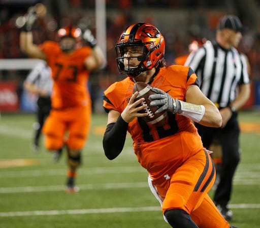 FILE - In this Oct. 8, 2016, file photo, Oregon State quarterback Darell Garretson runs into the end zone with the winning touchdown in overtime in an NCAA college football game against California, in Corvallis, Ore. Oregon State hosts Washington State on Saturday. (AP Photo/Timothy J. Gonzalez, File)