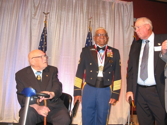 Medal of Honor recipient Melvin Morris, an Okmulgee native, center, after his induction into the Oklahoma Military Hall of Fame. Seated is Medal of Honor recipient Bennie Adkins, who was inducted in 2015. [Photo provided by John Greiner]