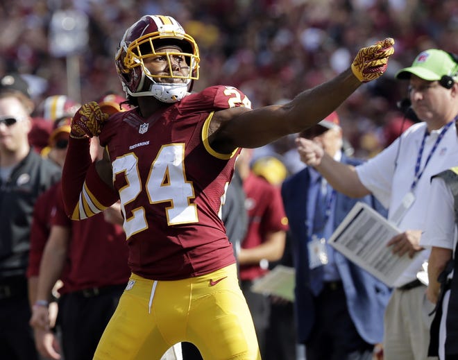 Washington Redskins cornerback Josh Norman (24) celebrates his interception with a "bow and arrow," gesture during the second half of a game against the Cleveland Browns on Oct. 2 in Landover, Md. Norman's celebration drew a fine from the league. (AP Photo/Chuck Burton, File)