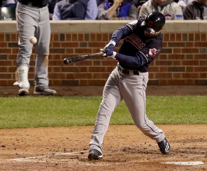 Cleveland Indians' Coco Crisp hits a RBI-single against the Chicago Cubs during the seventh inning of Game 3 of the Major League Baseball World Series Friday, Oct. 28, 2016, in Chicago. (AP Photo/Charles Rex Arbogast)