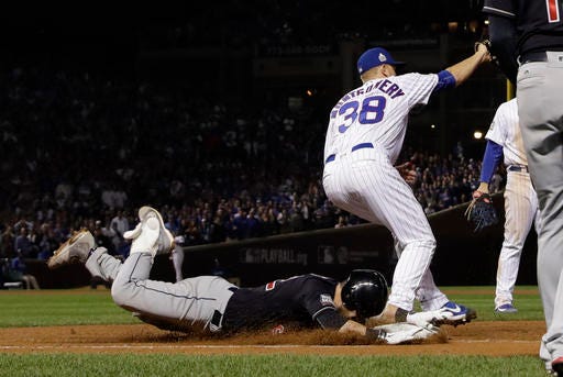 Cleveland Indians' Jason Kipnis is out at first as Chicago Cubs' Mike Montgomery takes the throw during the seventh inning of Game 3 of the Major League Baseball World Series Friday, Oct. 28, 2016, in Chicago. (AP Photo/David J. Phillip)