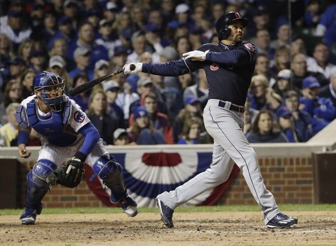 Cleveland Indians’ Coco Crisp hits an RBI single during the seventh inning of Game 3 of the Major League Baseball World Series against the Chicago Cubs Friday, Oct. 28, 2016, in Chicago. (AP Photo/David J. Phillip)
