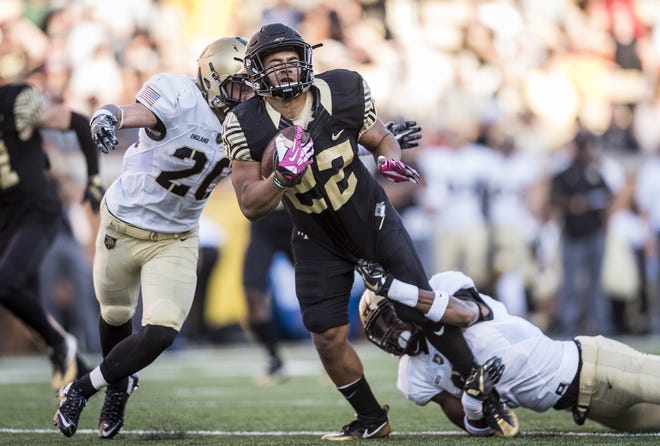 Wake Forest running back Ryan Janvion (22) is tackled by Army defensive back Rhyan England (20) during Saturday's game in Winston-Salem, N.C. Associated Press