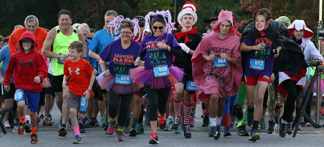 Runners begin at the start of the four-mile race at the 4-2-1 Costume Dash held Saturday morning at Holy Angels in Belmont. PHOTO MIKE HENSDILL/THE GAZETTE