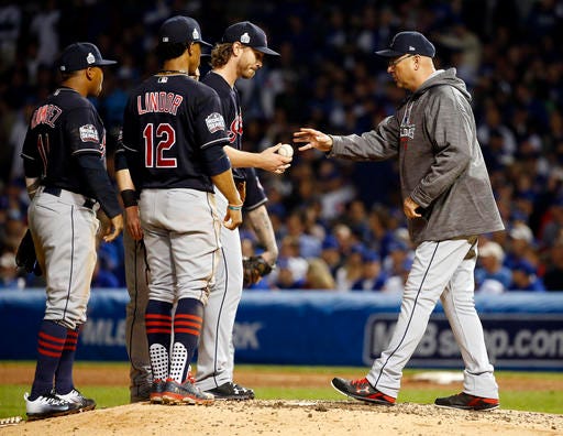 Cleveland Indians manager Terry Francona, right, takes the ball from starting pitcher Josh Tomlin during the fifth inning of Game 3 of the Major League Baseball World Series against the Chicago Cubs, Friday, Oct. 28, 2016, in Chicago. (AP Photo/Nam Y. Huh)