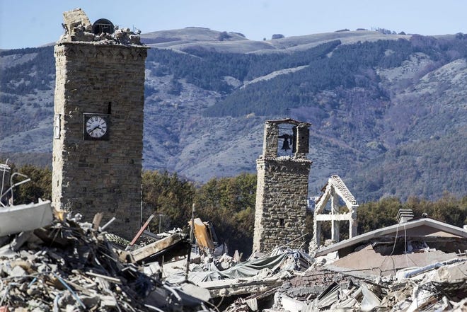 A view of the town of Amatrice, with the bell tower visible at left, after an earthquake with a preliminary magnitude of 6.6 struck central Italy, Sunday, Oct. 30, 2016. A powerful earthquake rocked the same area of central and southern Italy hit by quake in August and a pair of aftershocks last week, sending already quake-damaged buildings crumbling after a week of temblors that have left thousands homeless. (Massimo Percossi/ANSA via AP)