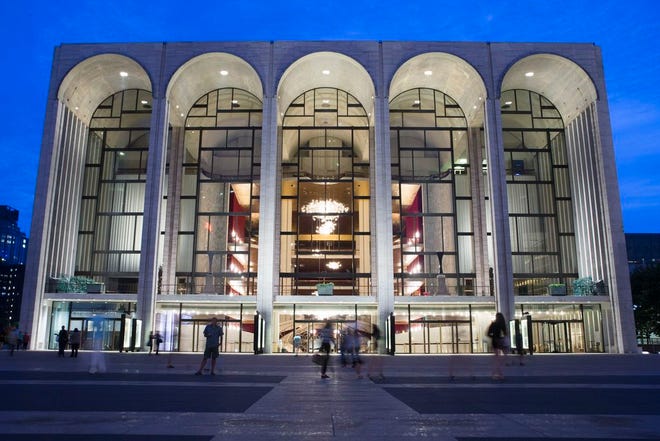 In this Aug. 1, 2014, file photo, pedestrians make their way in front of the Metropolitan Opera house at New York's Lincoln Center. New York's Metropolitan Opera stopped a performance Saturday, Oct. 29, 2016, after someone sprinkled an unknown powder into the orchestra pit. Met spokesman Sam Neuman said Saturday afternoon's performance of "Guillaume Tell" was canceled during the second intermission because of the incident. A police spokeswoman said the person who sprinkled the powder fled and is being sought. (AP Poto/John Minchillo, File)