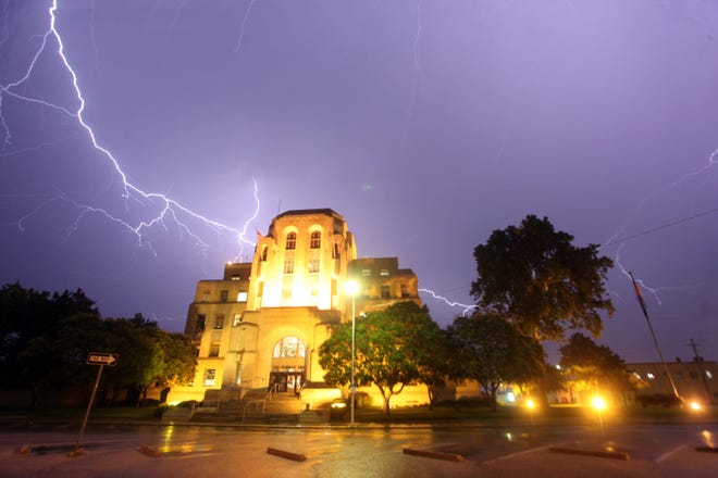 Lightning streaks arcross the sky above the Reno County Courthouse. Unexplained things have been reported to happen on the fifth floor after sunset.