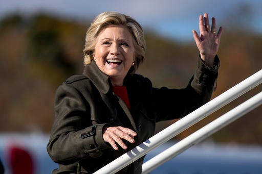 Democratic presidential candidate Hillary Clinton waves to members of the media as she boards her campaign plane at Westchester County Airport in White Plains, N.Y., Monday to travel to Cleveland for a rally.