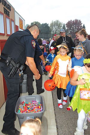 Sturgis police and fire personnel were among the many who passed out candy to the many trick-or-treaters at Safety Town’s “Halloween Extravaganza” Saturday. About 3,100 people attended the event.