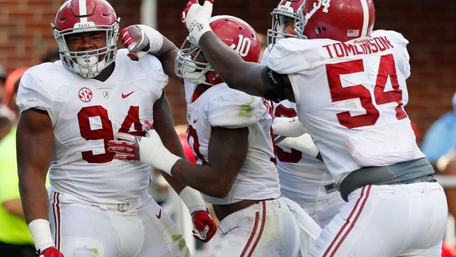 Alabama defensive lineman Da’Ron Payne (94) celebrates his fumble recovery for a touchdown with teammates on Sept. 17, when the Crimson Tide rallied from a 21-point deficit to post a 48-43 victory. CREDIT: Kevin C. Cox/Getty Images