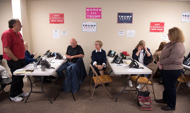 Volunteers wait for their next assignment at the Bucks County Trump Pence headquarters in Newtown Township on Monday, Oct. 31, 2016.