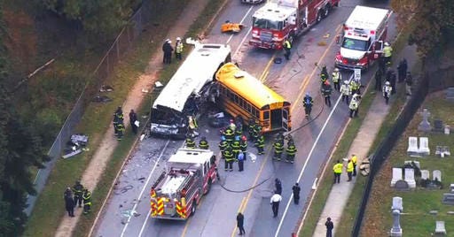 In this frame from video, emergency personnel work at the scene of a fatal school bus and a commuter bus crash in Baltimore, Tuesday, Nov. 1, 2016. -(WBAL-TV via AP)