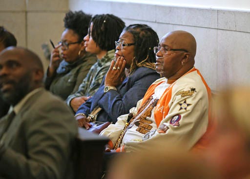 Sam Johnson, right, father of the late Samuel DuBose, sits in Hamilton County Common Pleas Judge Megan Shanahan's courtroom for the start of the jury selection process for Ray Tensing's murder trial Tuesday, Oct. 25, in Cincinnati. The former University of Cincinnati police officer is charged with murder in the shooting death of Samuel DuBose. Tensing remains free on a $1 million bond. His attorney Stew Mathews has said Tensing fired a single shot because he feared for his life. Jury orientation and the filling out of lengthy questionnaires are planned for Tuesday. (Carrie Cochran/The Cincinnati Enquirer via AP, Pool)