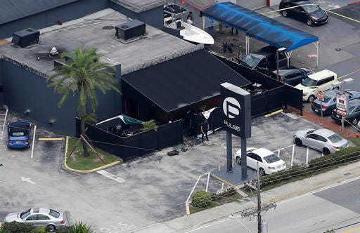 In this June 12 photo, law enforcement officials work at the Pulse gay nightclub in Orlando, Fla., following a mass shooting. Police negotiators talking to gunman Omar Mateen at first weren't sure if the person they had on the phone was actually in the Pulse nightclub, according to audio recordings released Monday after a judge ruled they should be made public. 
AP Photo/Chris O'Meara, File