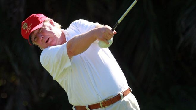 Donald Trump hits a tee shot at Trump International Golf Club. (Allen Eyestone/The Palm Beach Post)