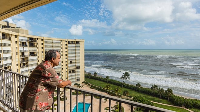 Gary Freedman looks out from his 12th story balcony at the Ocean Trail Condominium on Wednesday, October 12, 2016. The Freedman’s chose to stay in their condo during Hurricane Matthew after an evacuation order was issued. (Joseph Forzano / The Palm Beach Post)