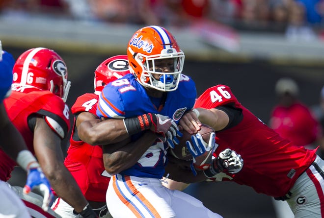 Florida Gators wide receiver Antonio Callaway (81) coughs up the ball under pressure from Georgia Bulldogs linebacker Michael Keene (46) during first half action as the Florida Gators take on the Georgia Bulldogs Saturday at EverBank Field in Jacksonville. Alan Youngblood/Special to the Guardian