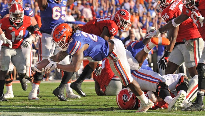 Florida’s #25, Jordan Scarlett dives across the goal line to score the Gator’s second touchdown of the game late in the second quarter of play. First half action at EverBank Field Saturday, October 29, 2016 of the annual Florida vs Georgia football game. Florida went into the half with a 10 to 14 lead over Georgia. (Florida Times-Union/Bob Self)