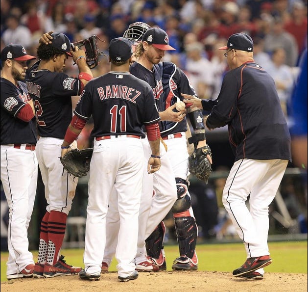 Starting pitcher Josh Tomlin hands the ball over the manager Terry Francona. (Bob Rossiter/The Repository)