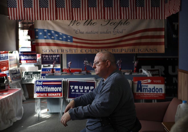 John Grooms of Madison, Maine, ponders the upcoming election at the Republican party headquarters in Skowhegan, Maine, on Oct. 20. Grooms said that he likes Donald Trump's stance on lowering taxes but that the candidate's theatrics make him a tough sell for some reserved New Englanders. "I don't like his crass and brash way," said Grooms. (AP Photo/Robert F. Bukaty)